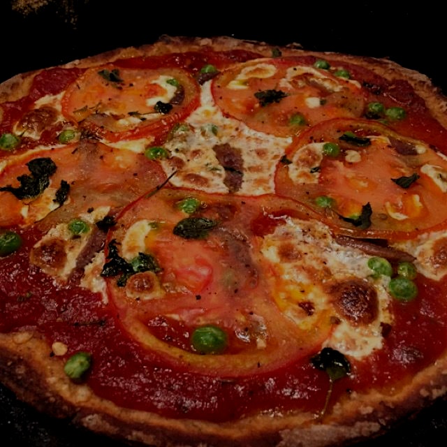 Whole wheat flax pizza dough, fresh mozzarella, fresh tomatoes, peas, anchovies and fresh oregano. 