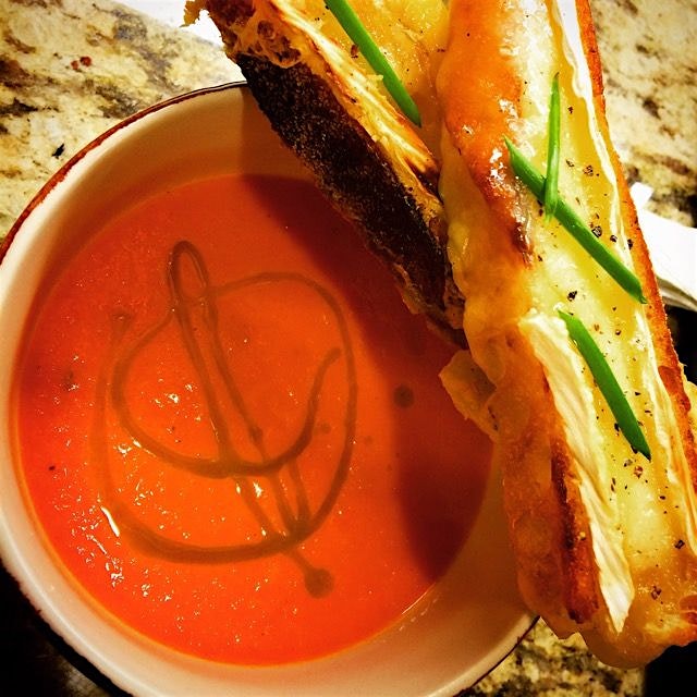 First Course: Roasted Red Bell Pepper Bisque w Brie Toast topped off w Basil Oil #farm2table #vda...