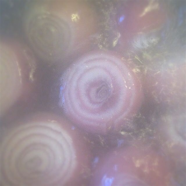 Smoke-filled view of boiling red onions on their way to sauce 