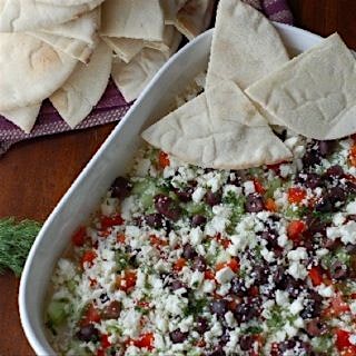 Greek Layer Dip from my food blog What's Cooking with Jim. It's a hummus dip with cucumber, red p...