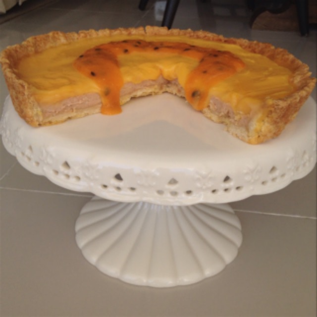Mamey sapote custard tart with passionfruit curd and passionfruit mango sour orange coulis.  Pret...