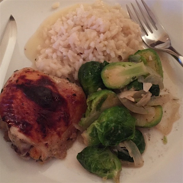 Sautéed chicken thigh with risotto and buttery brussel sprouts.