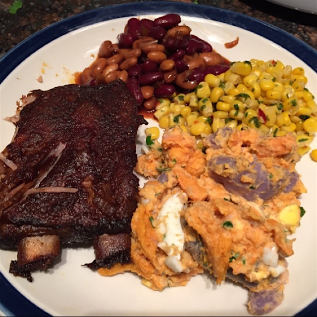 Slow cooked ribs, slow cooker bbq beans, blue and sweet potato salad and corn with chills and cil...
