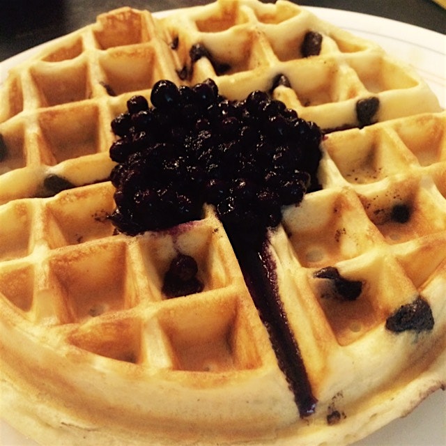Belgian waffles with chocolate chips and blueberry syrup 