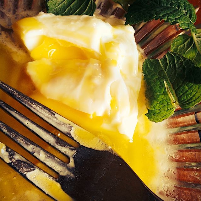 Beautiful poached eggs with fresh goat butter and a sprig of mint from the window garden - magnif...