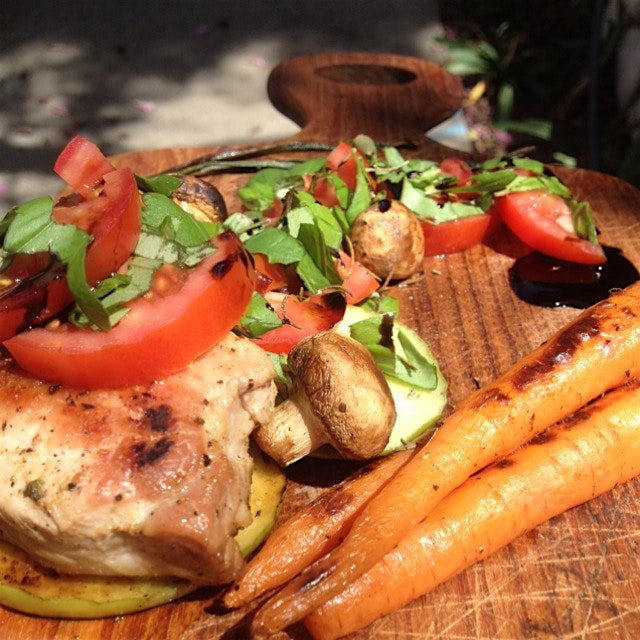 Fried sour apple pork chop with carrots and a tomato basil salsa.
