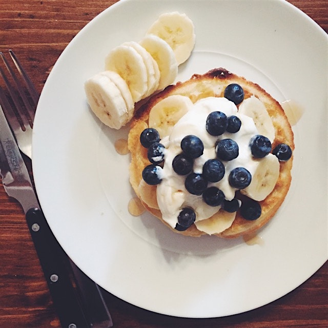 Gluten free waffle topped with Greek yogurt, bananas, blueberries and a drizzle of Vermont maple ...