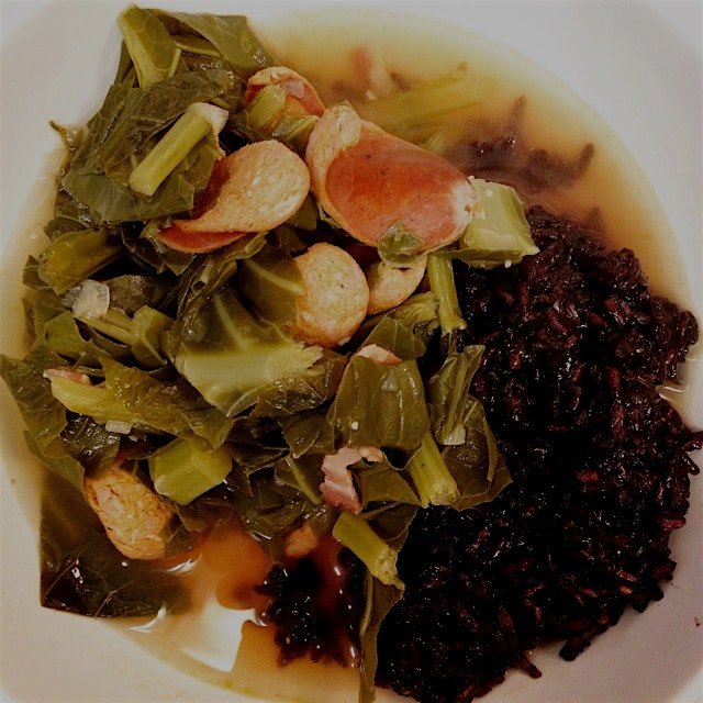Greens with smoked andouille and a bit of bacon over black rice. 