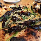 Wood fired pizza with ramps, pecorino romano, nduja.