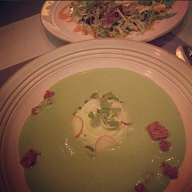 Chilled spring peas soup was poured over a dollop of pea cream, espellette pepper croutons, pickl...