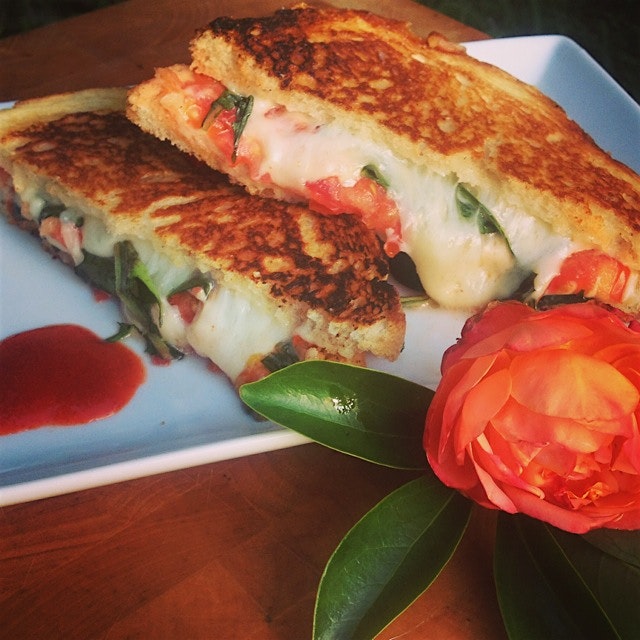 Manchego and Swiss Grilled cheese sandwich with shaved onion, sliced tomato, and dandelion greens:) 
