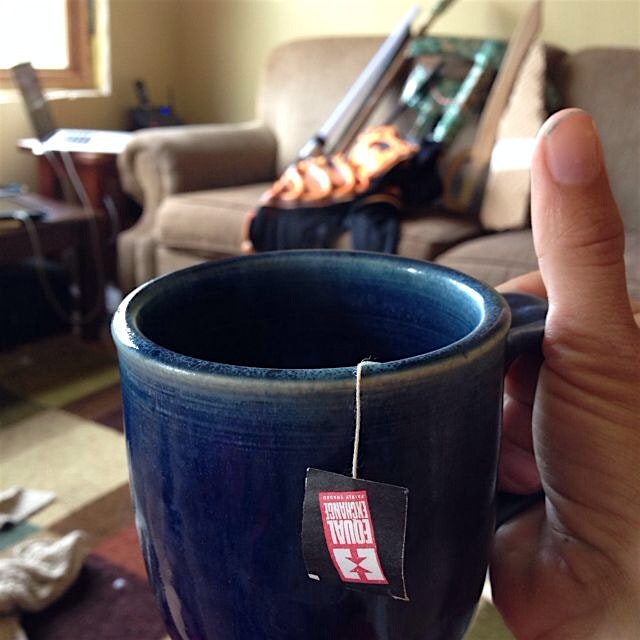 Morning fair trade tea while contemplating the arsenal of toy weapons on the couch across from me 