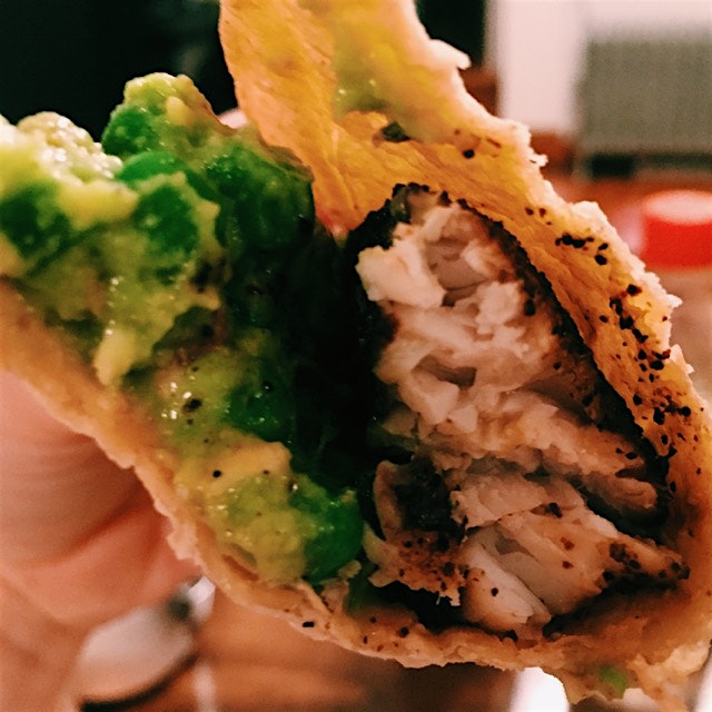 Grilled mahi mahi taco with spring pea guac