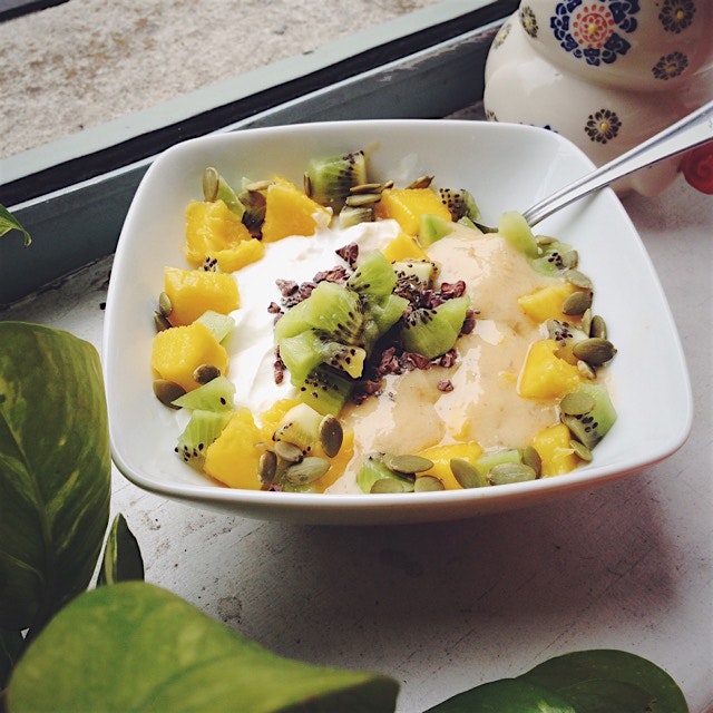 Banana mango 'nice cream' and plain greek yogurt topped with mango, kiwi, pepitas, chia seeds and...