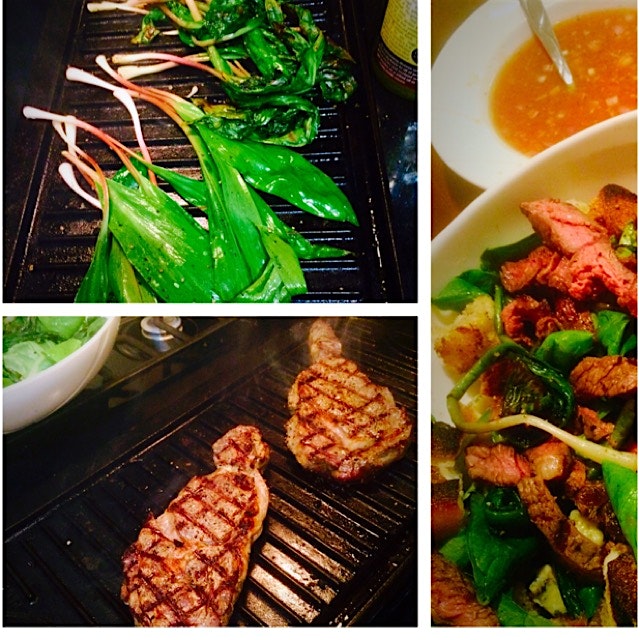 Grilled ramps and grass fed steaks over spring greens with grilled garlic crotons and a game chan...