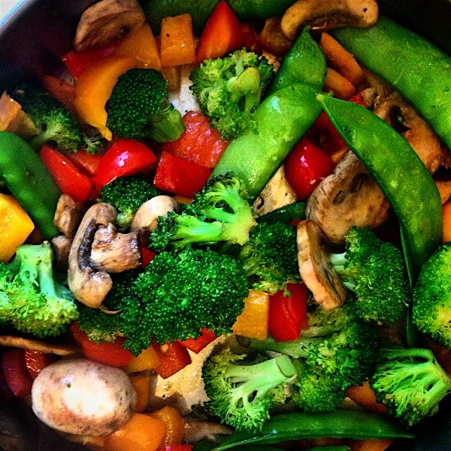 Weekend veggie stir fry pre brown rice and peanut sauce mixed in.