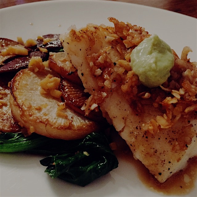 Rice flake crusted hake with crispy mushrooms, daikon radishes, and yu choy with yuzu-soy sauce a...