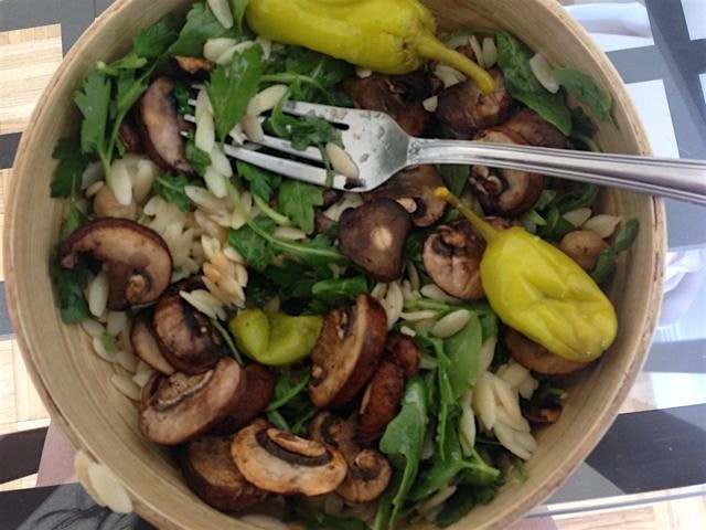 Orzo salad with kalamata olives, peperoncino, parsley, chickpeas, and mushrooms. Dressed with sim...