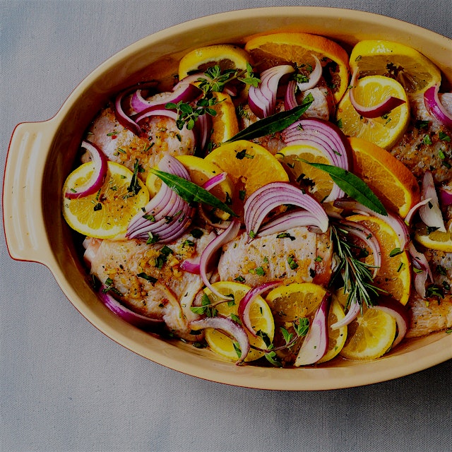 Citrus sunshine in my kitchen:  chicken thighs nestled in lemon and orange slices with a marinade...