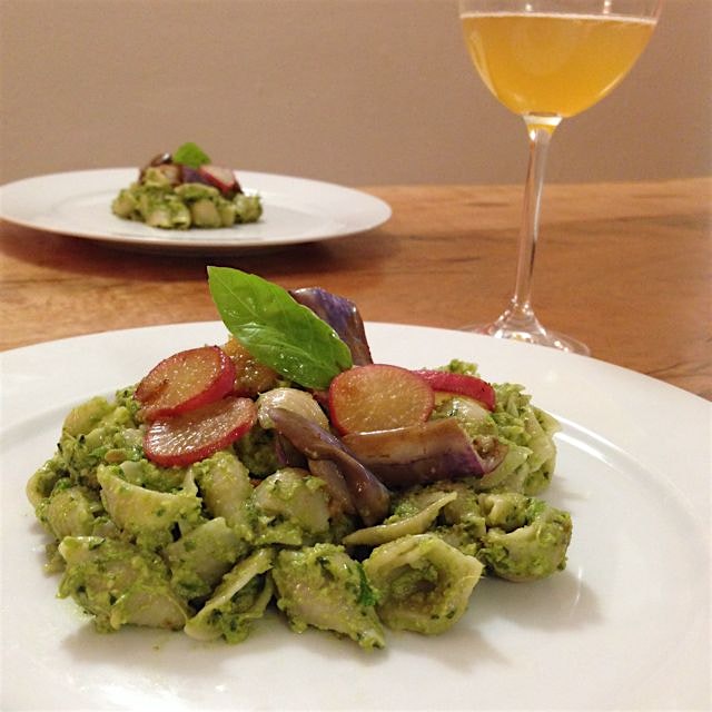 Created a spiced vegan kale basil pesto brown rice pasta topped with sautéed fairytale eggplant p...