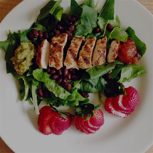 Pan grilled chicken, black beans, guacamole, and salsa on spinach and lettuce from the vegetable ...