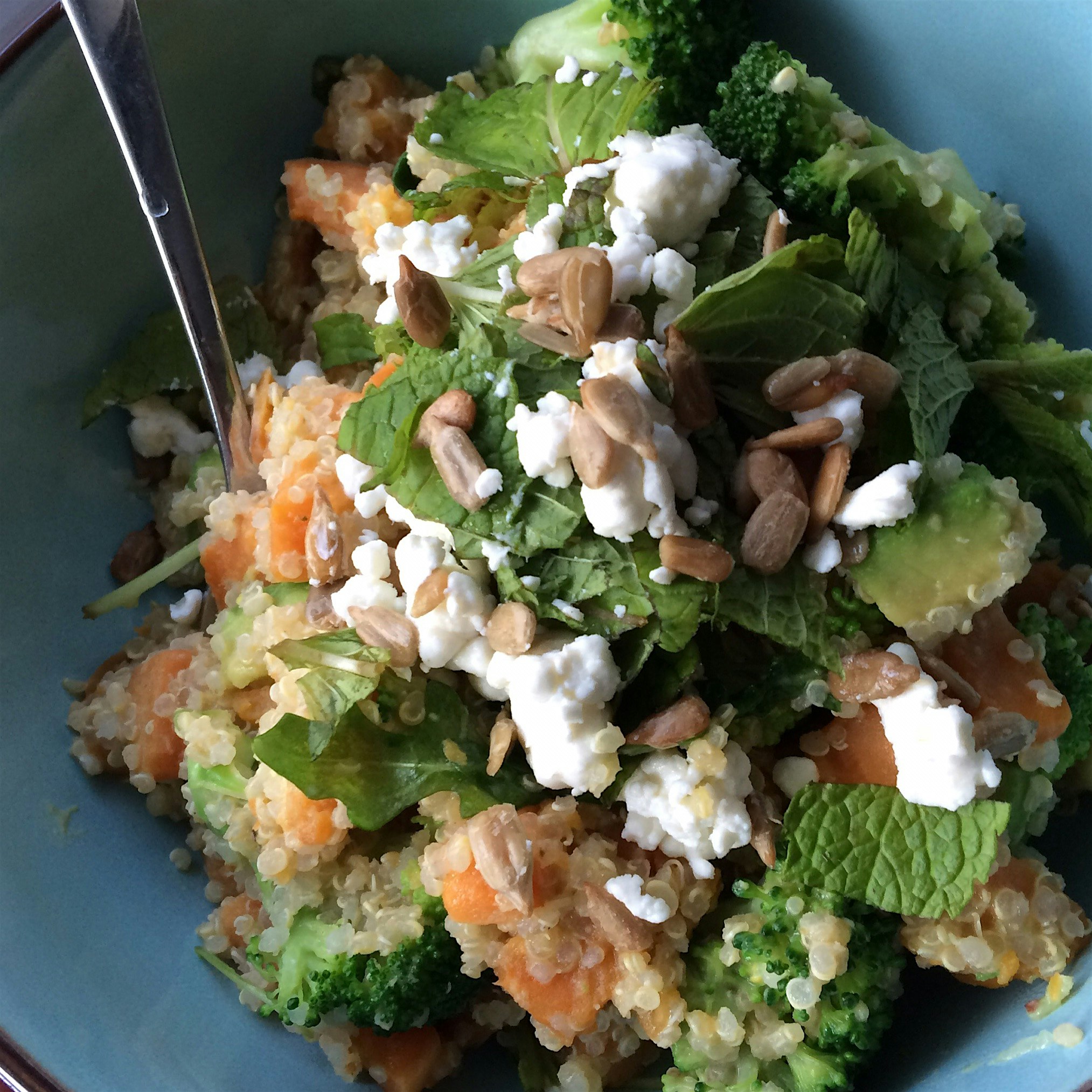 Colorful super foods dinner - chock full of quinoa, sweet potato, and broccoli - drizzled with ta...