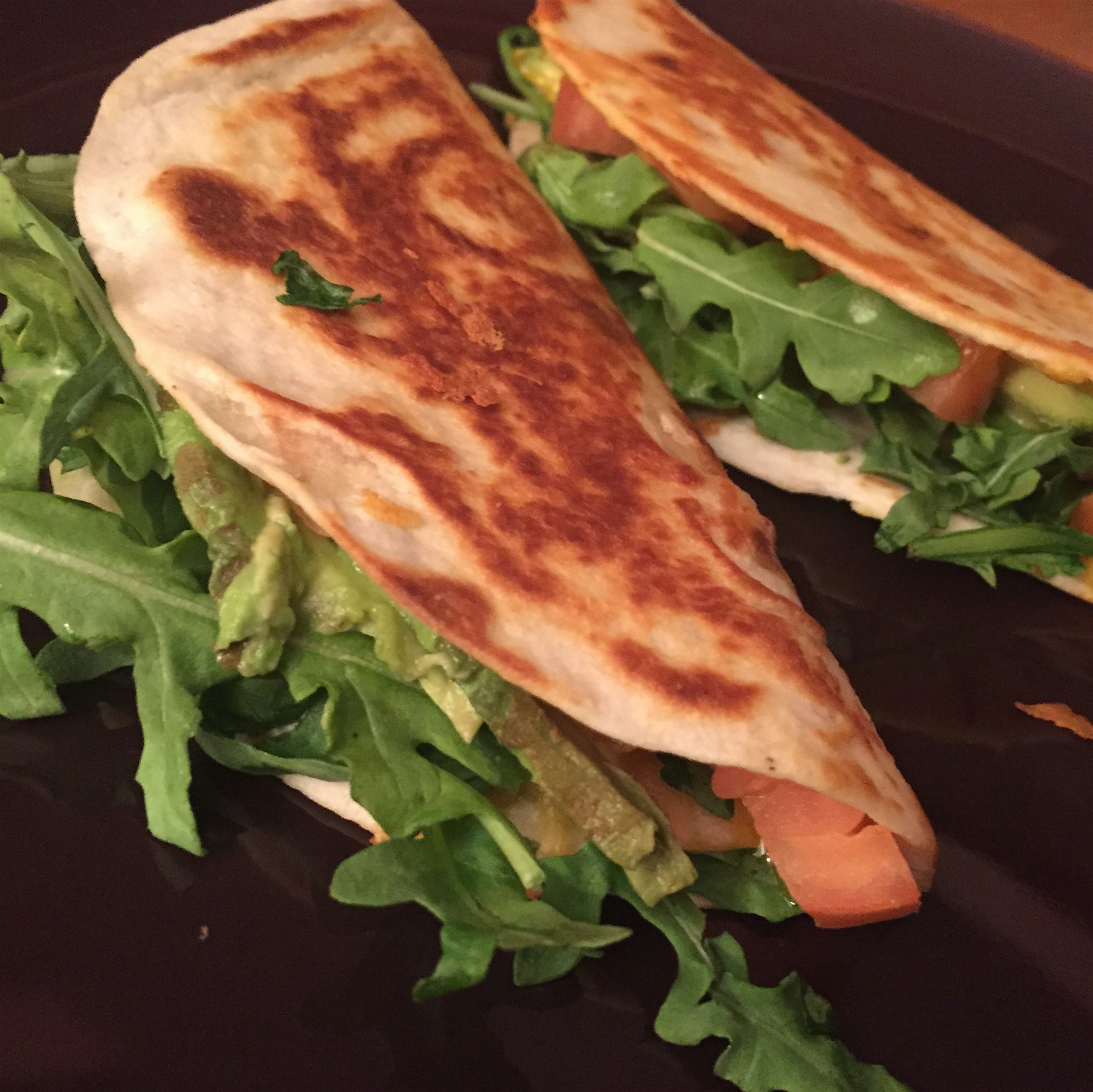 Dinner for one! Quick quesadillas with fresh arugula, tomatoes, and avocado, finished with black ...