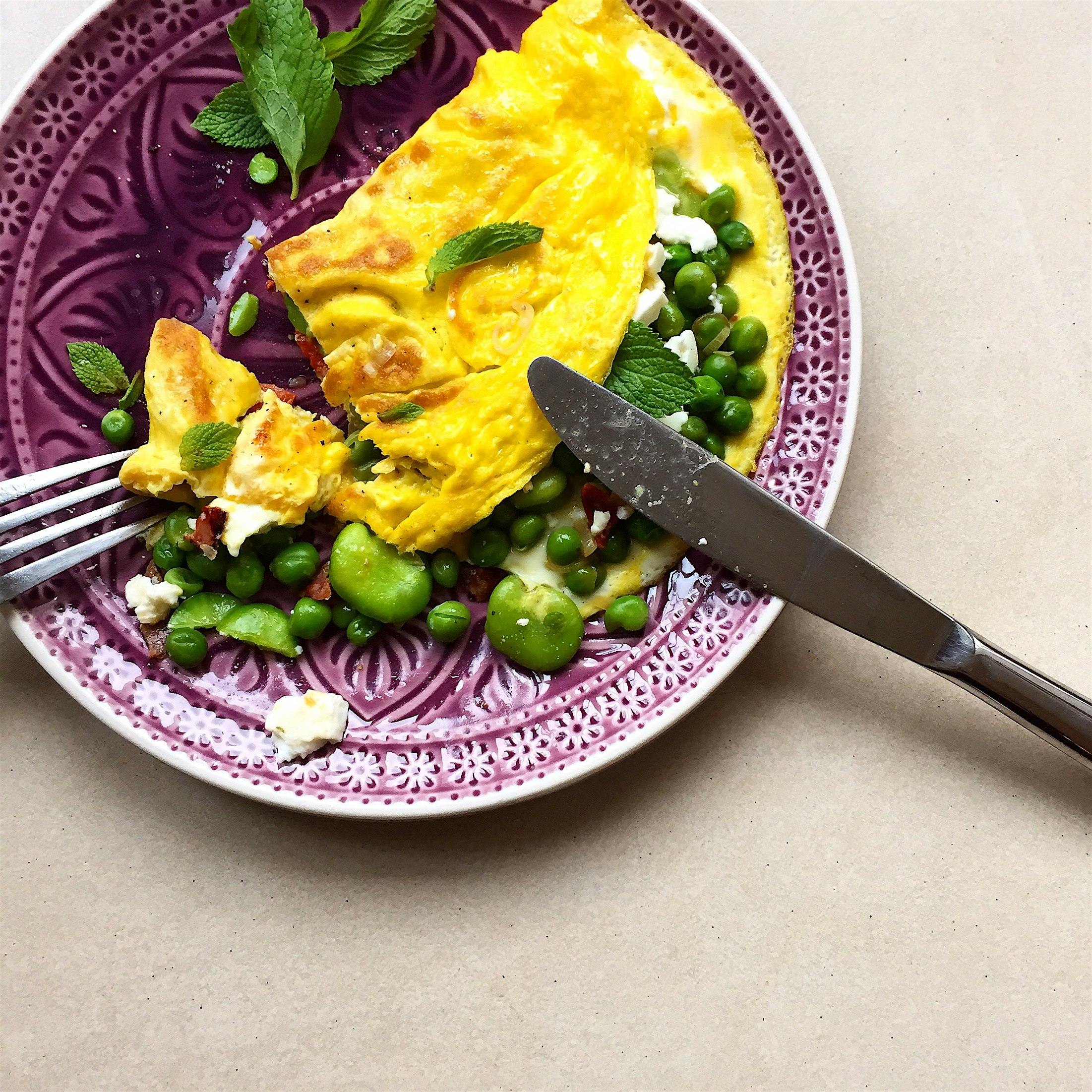 Omelette with the left over broad beans and peas I cooked last night, plus crumbled feta for a ta...