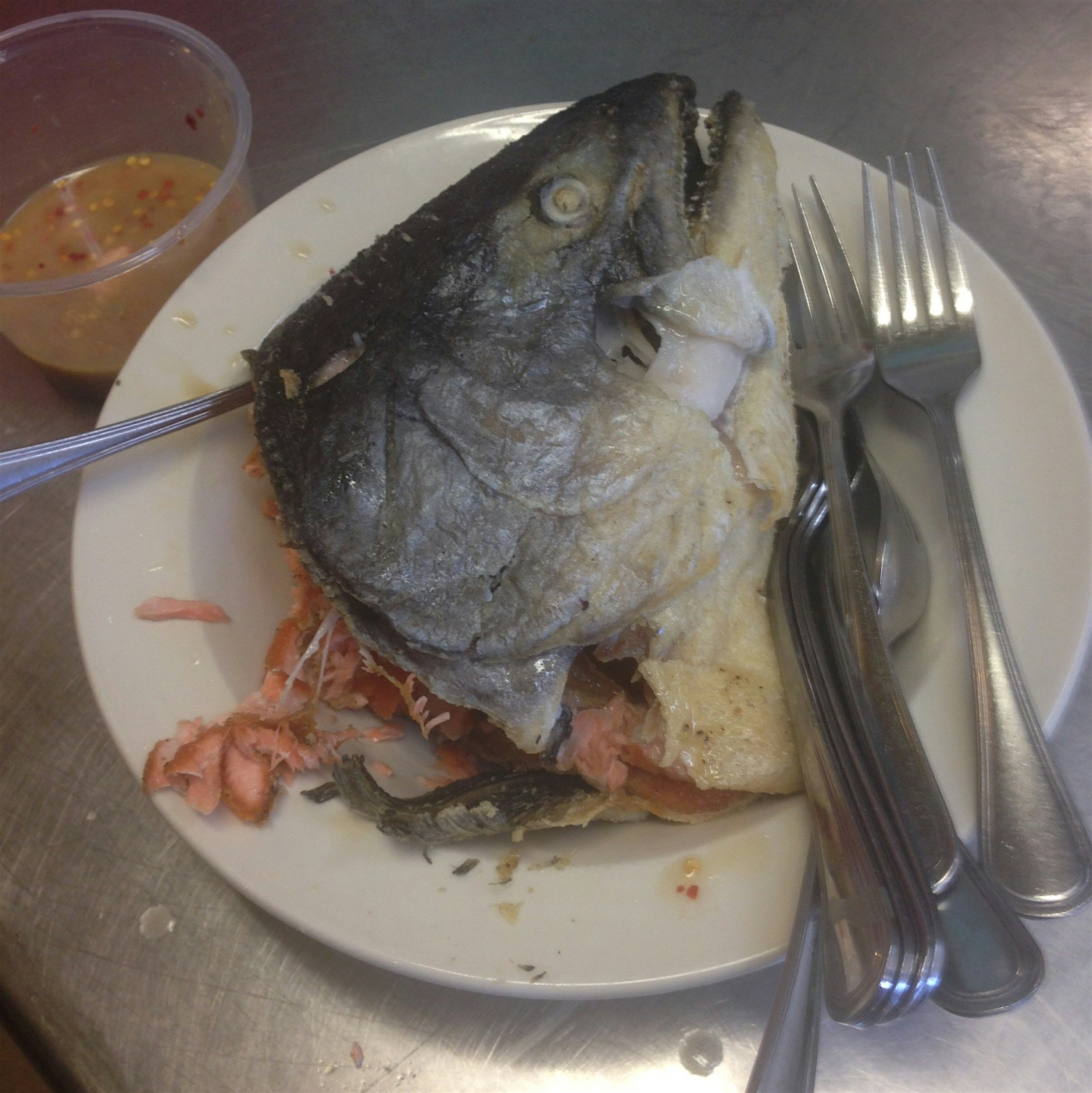 Mid-day kitchen snack: deep-fried wild pacific salmon head with nuoc cham style dipping sauce. I ...