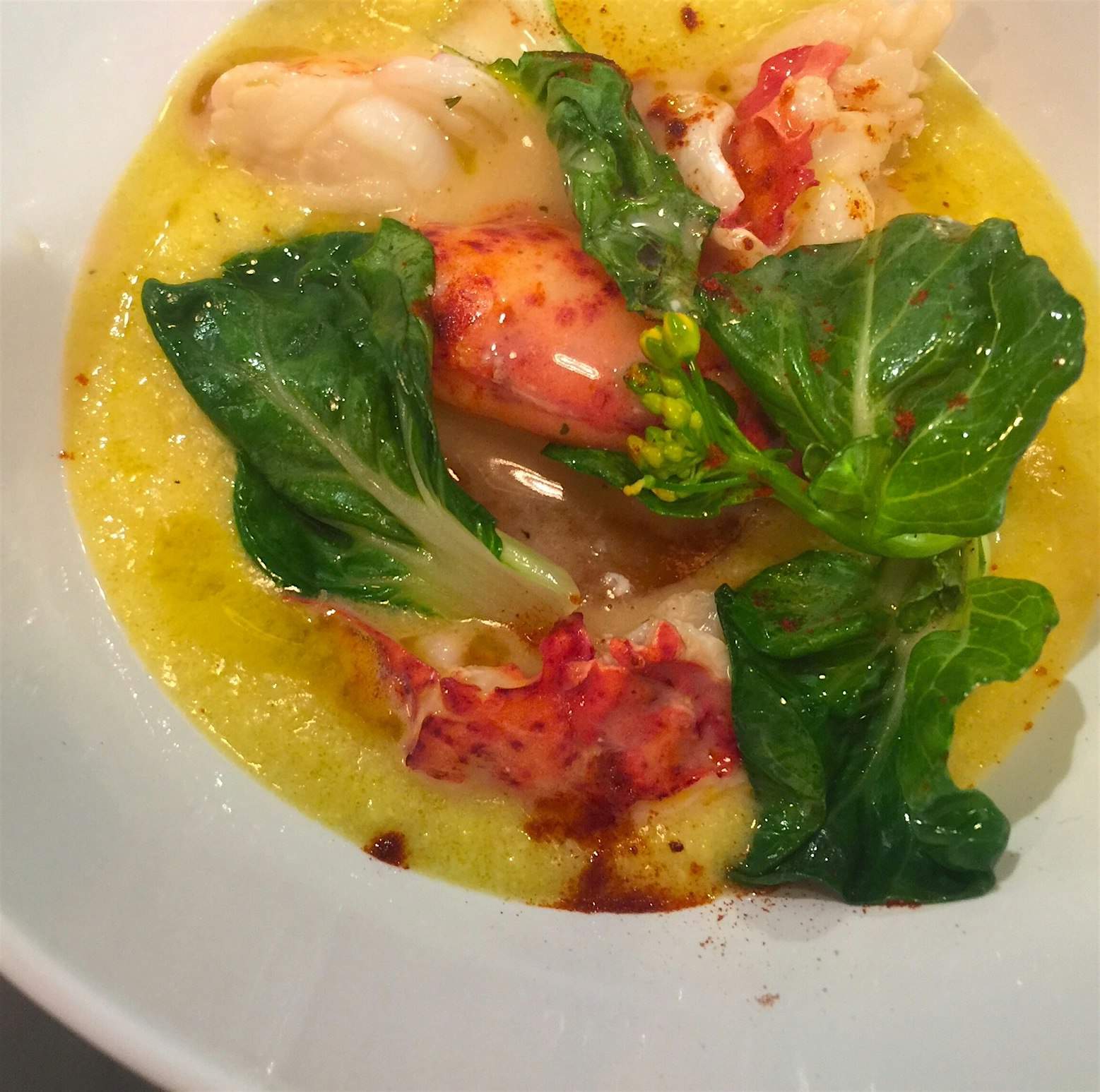 Lobster poached in butter sauce with crispy potatoes, bok choy and roasted corn bisque. 🌽