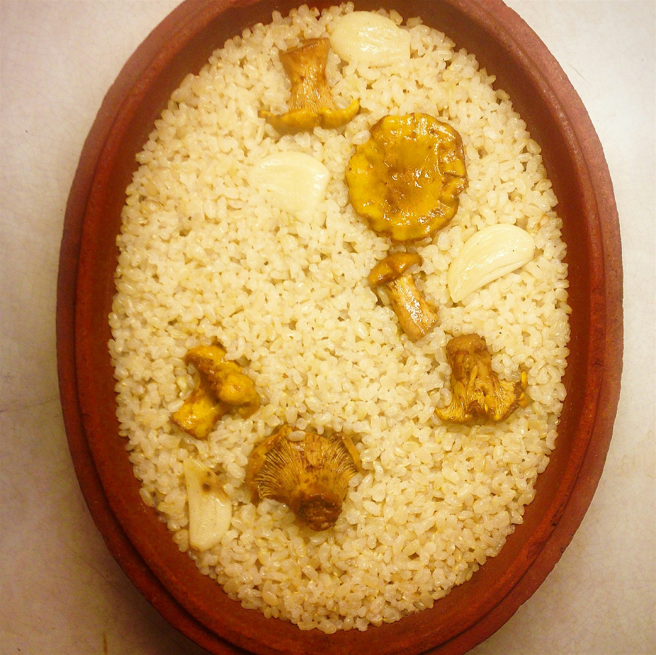 Short grain brown rice scented with chanterelles and garlic served with a ton more chanterelles a...