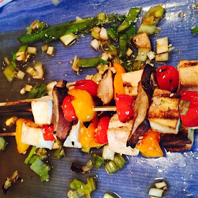 Tofu skewers marinated in a ginger soy honey sesame glaze with scallions and sesame seeds. 