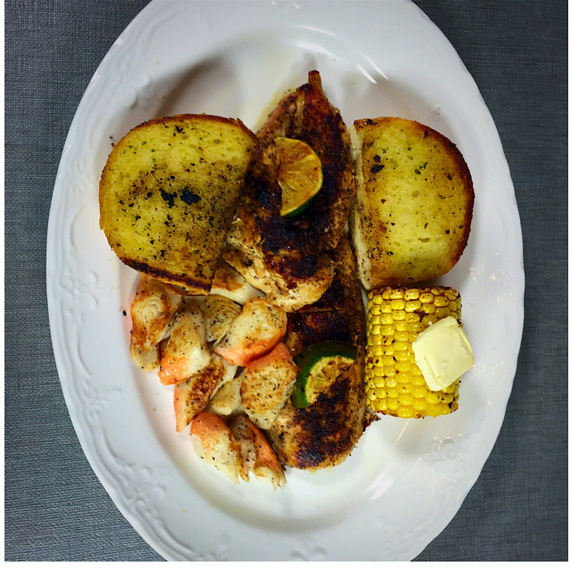 #surfnturf crab and chicken with corn on the cob and a squeeze of lime with garlic toast.