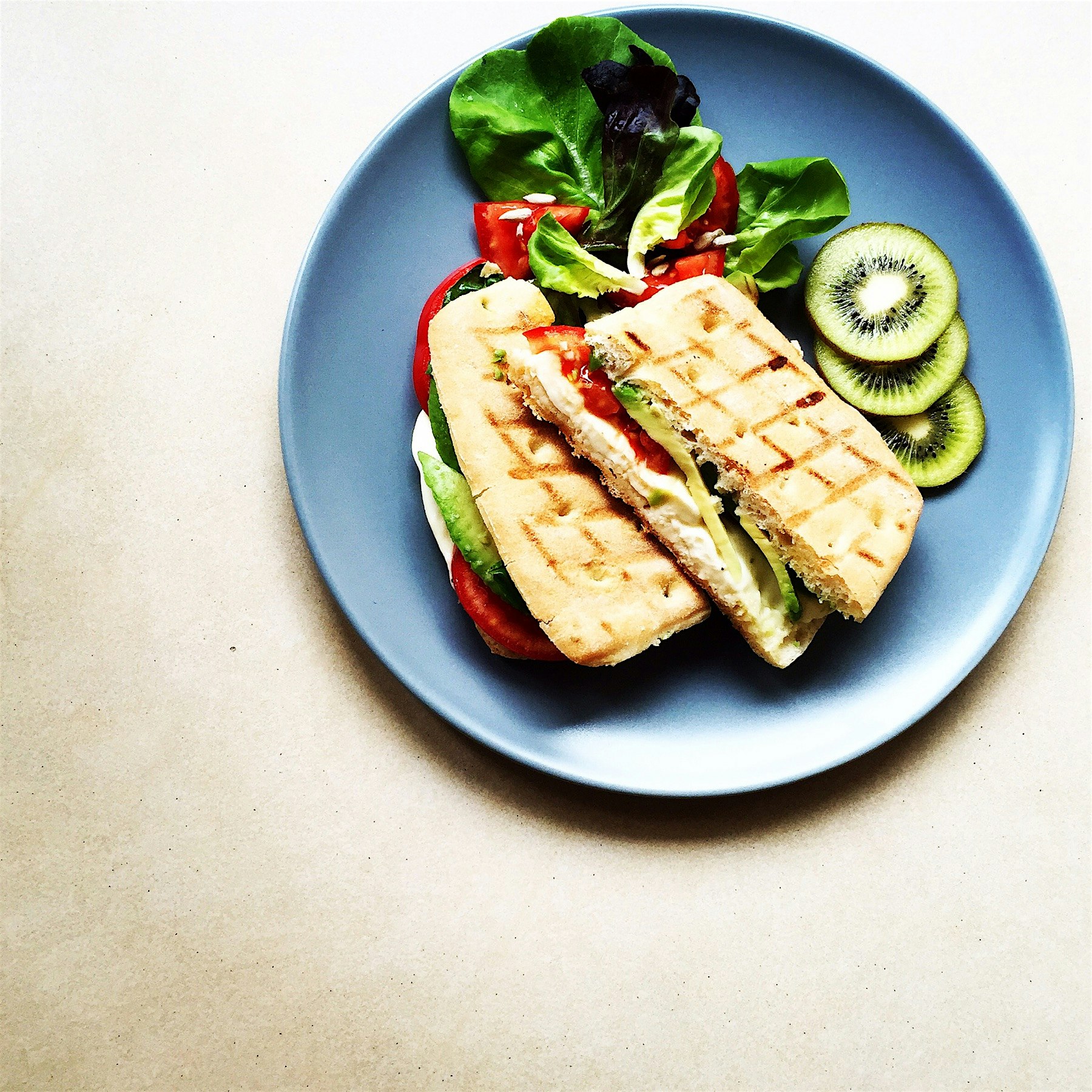 Grilled focaccia with tomato, avocado, basil and mozzarella 