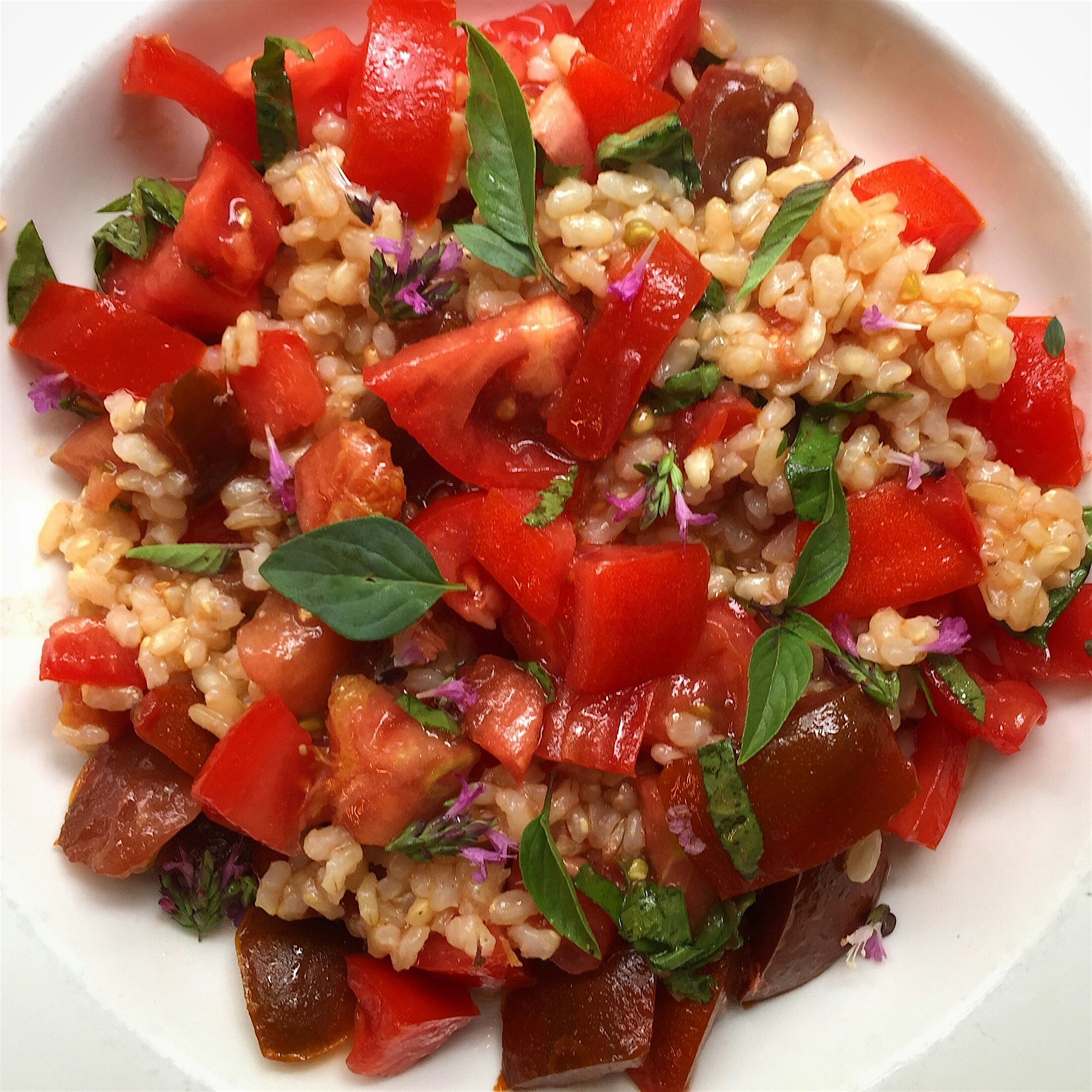 Short grain brown rice, tomatoes and oregano flowers. 