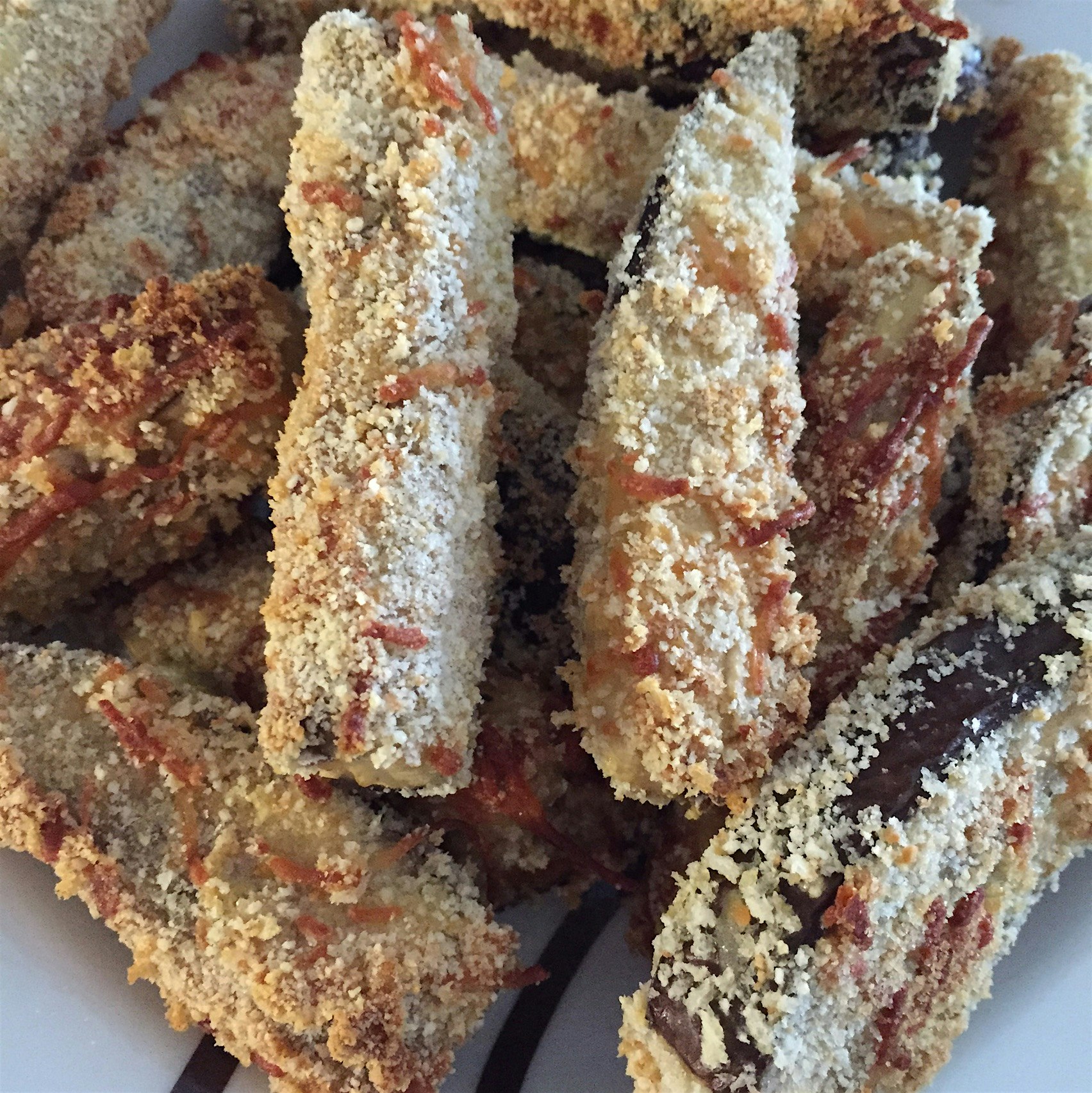 Eggplant fries dipped in egg, Parmesan & breadcrumbs. Baked!