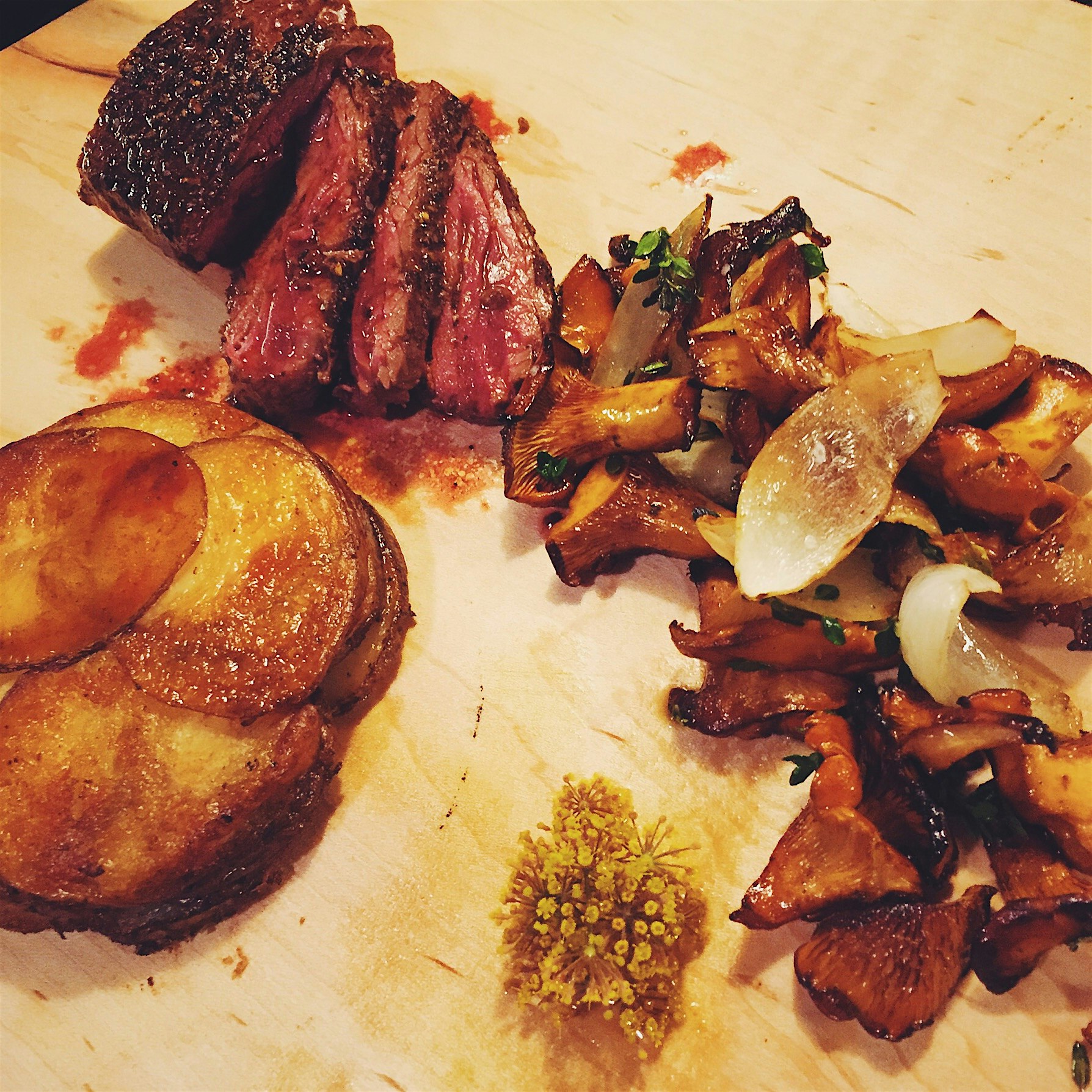 Local hanger steak, pommes Anna with chanterelles and fennel flowers. 
