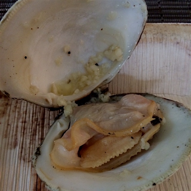 Grilled little neck clam with garlic butter, perfect start to a summer meal.