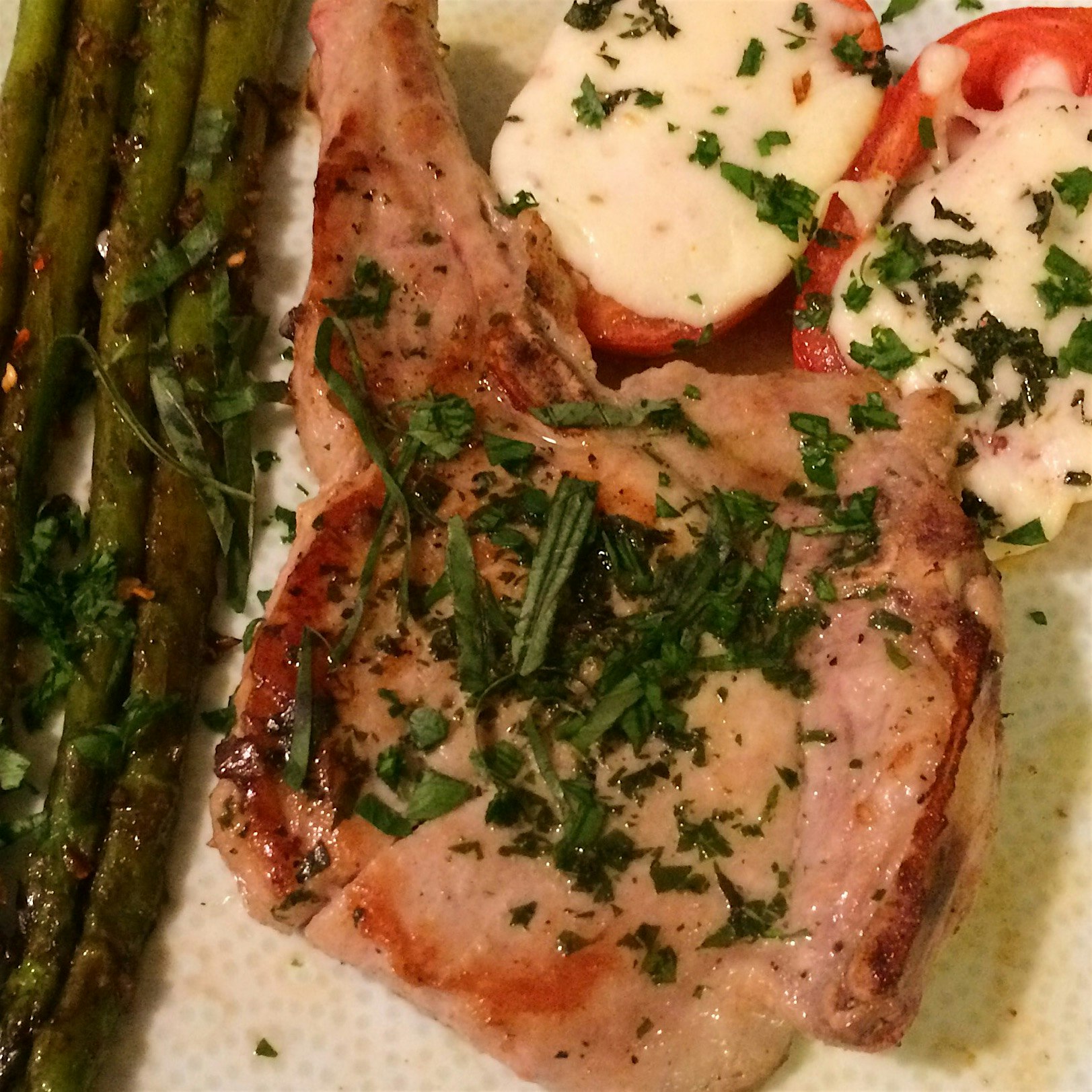 Italian Pork Chop with Mozzarella Baked Tomatoes and Asparagus. Haven't quite got the hang of pla...