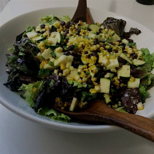Charred corn and red lettuce salad with black beans and zucchini in a roasted jalapeño lime dress...