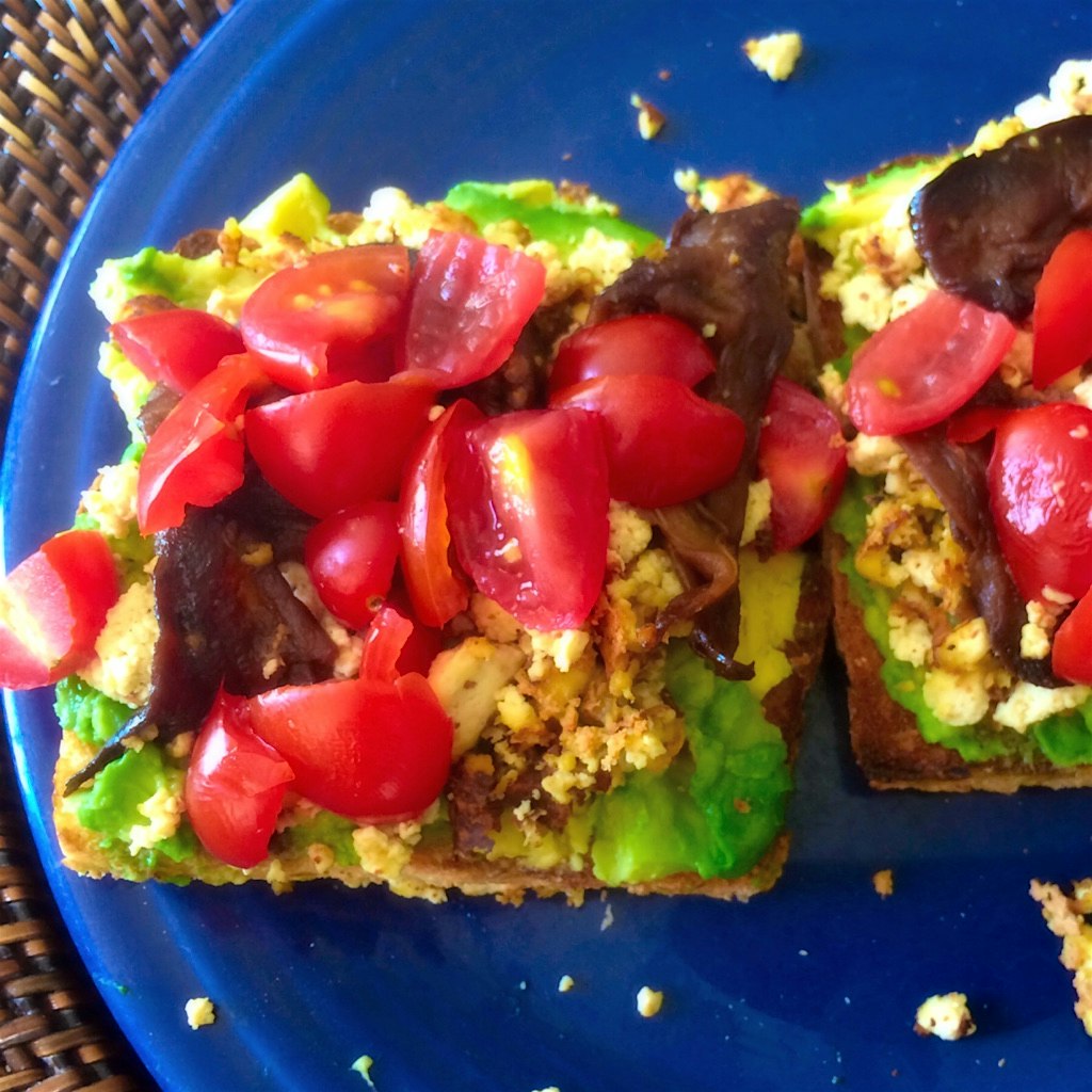 Amped up vegan avocado toast with tofu scramble and smoky eggplant.
