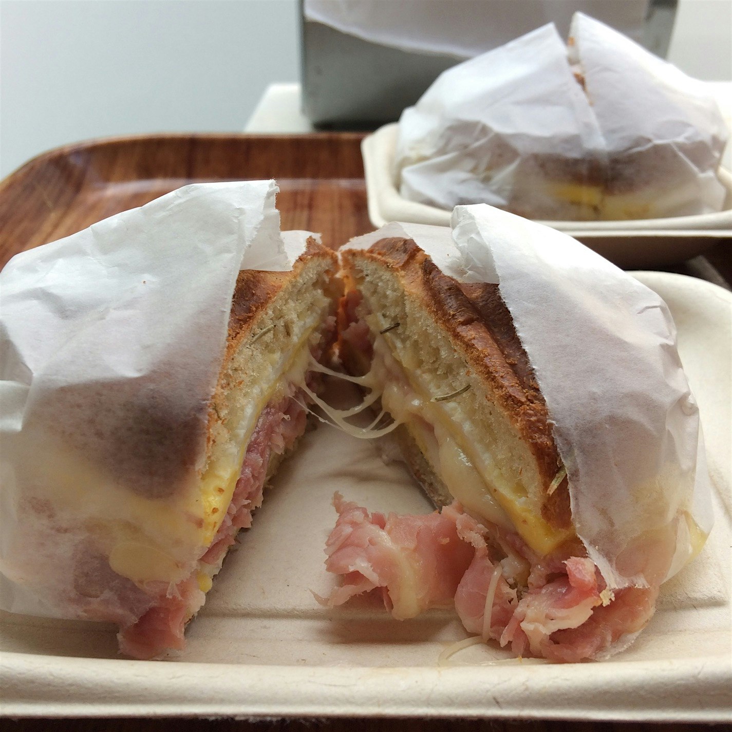 This breakfast sandwich starts w house made rosemary roll, holding fried egg, house made Parisian...