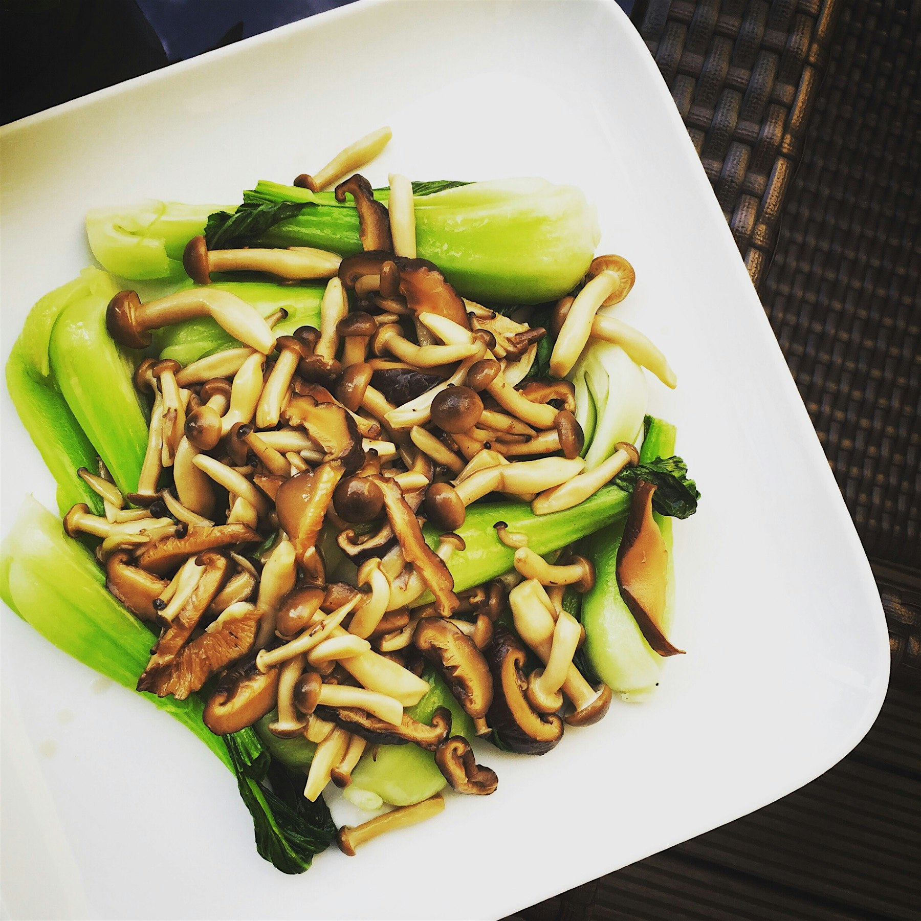 Braised Shimeji and shiitake mushrooms with oyster sauce on a bed of quick-fried shanghainese Pak...