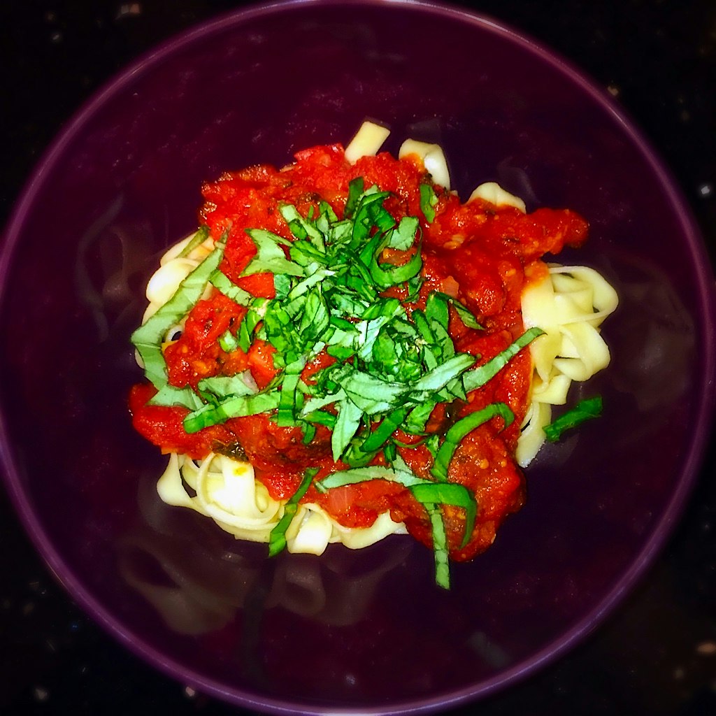 Homemade meatballs and slowly simmered pasta sauce atop a small bed of fettuccini. Served with a ...