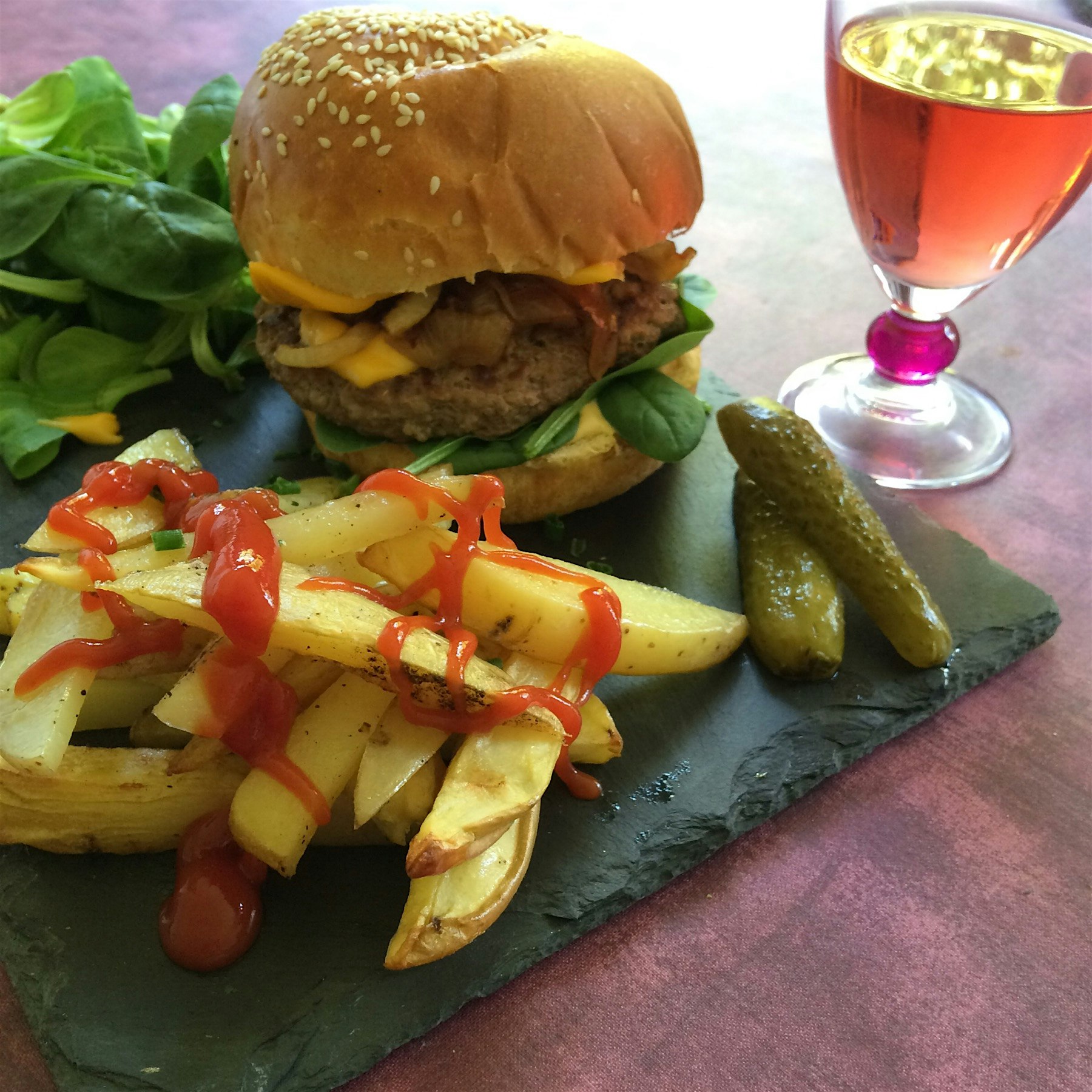 Organic Cheeseburger with spinach and caramelized onions and Oven-baked fries 