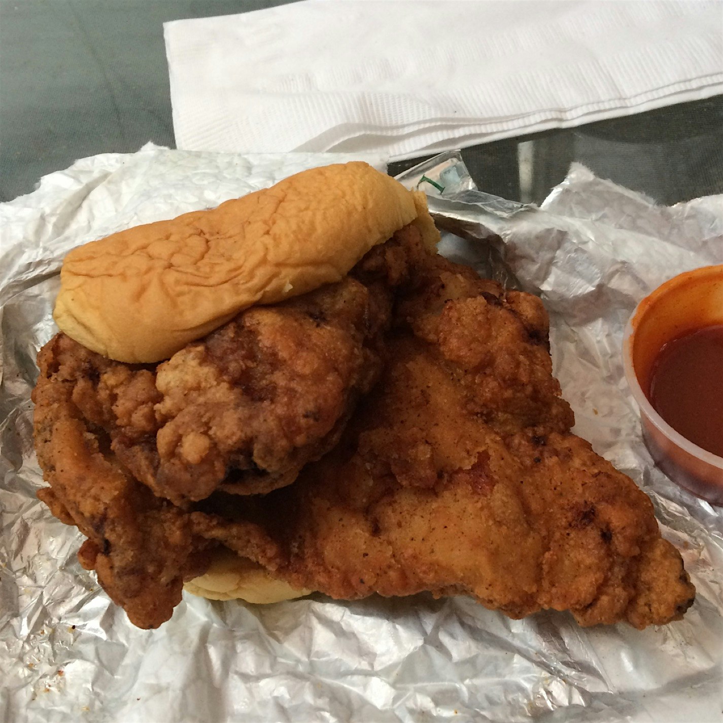 Spicy marinated fried chicken sandwich from David Chang's Fuku. Served with pickles, chickpea but...