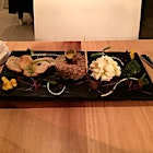 Ostrich steak tartare - a South African delicacy with local condiments including quail egg and edible local flowers 