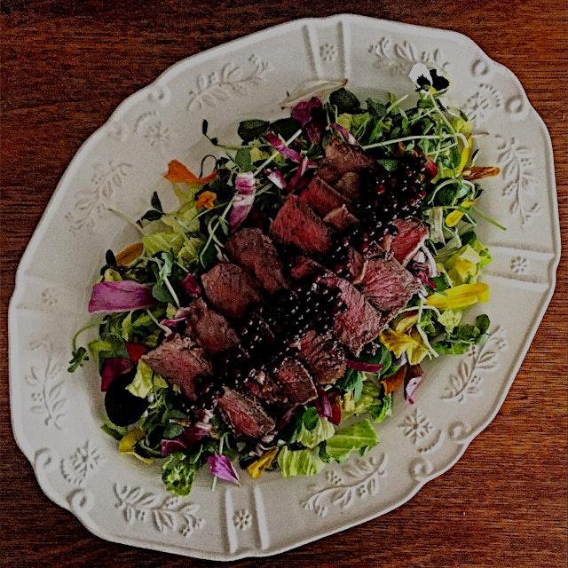 The attempt to hang on to summer for a few more days. Grilled ribeye and elderberries over greens...