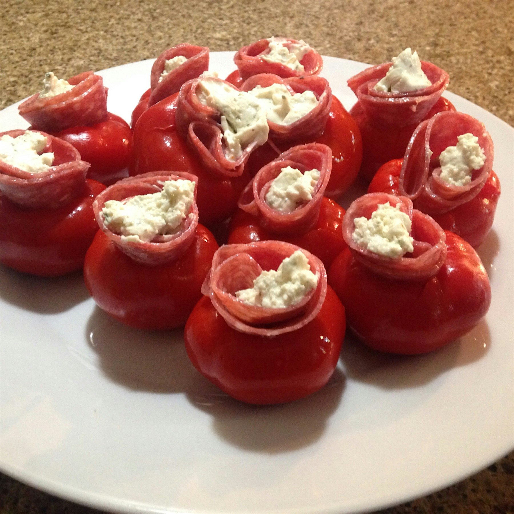 Homemade vinegar cherry peppers stuffed with salami and a soft herb cheese. 