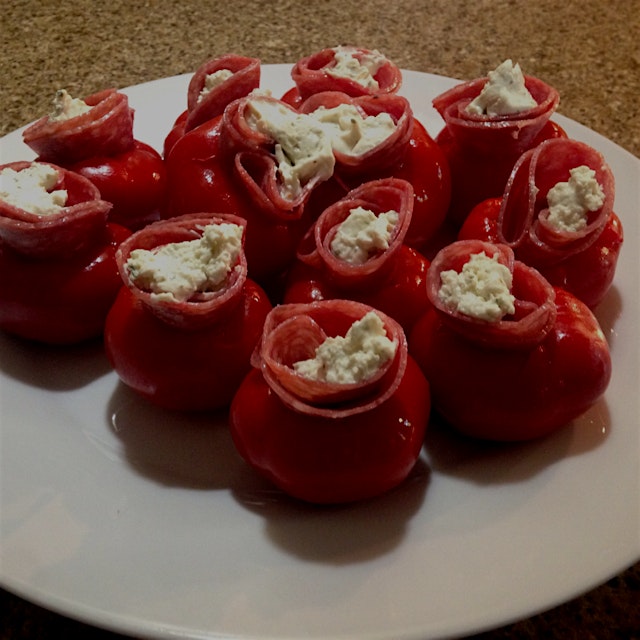 Homemade vinegar cherry peppers stuffed with salami and a soft herb cheese. 